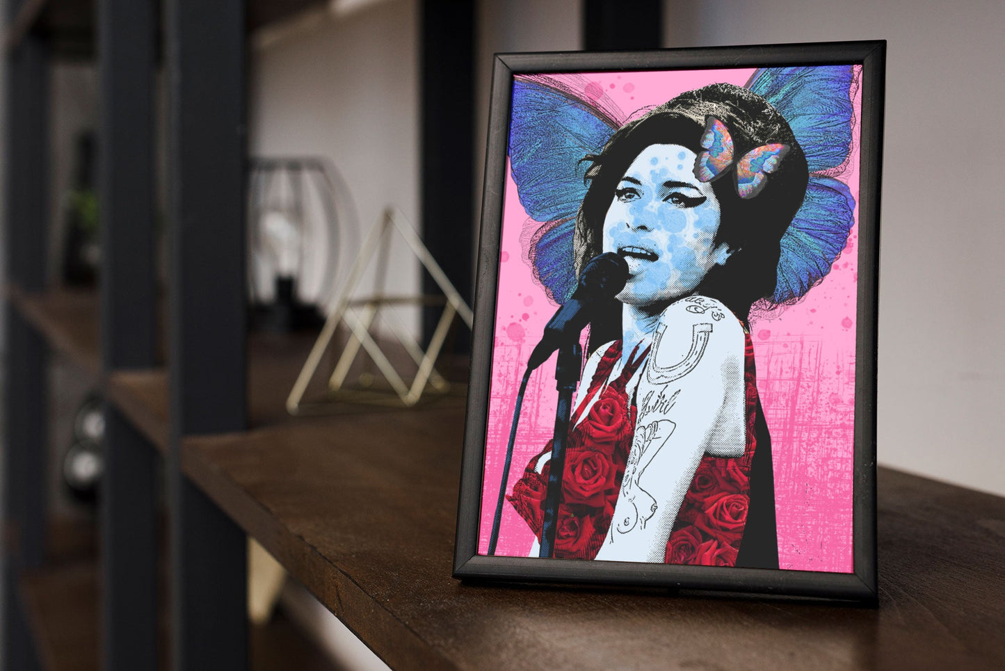 Amy Winehouse Pop Art Print in black frame on shelf